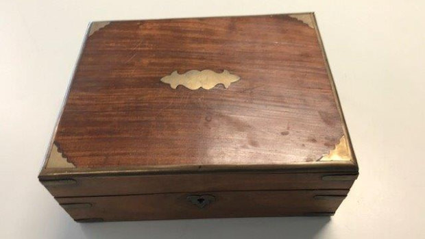 A wooden box containing what appears to be human ashes has been found in the boot of a stolen rental car. 