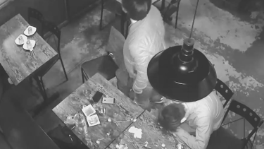 CCTV footage shows a patron asleep at a table inside the restaurant.