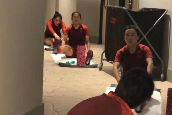 The Chinese soccer team goes through their paces in the corridors of the Westin in Brisbane.