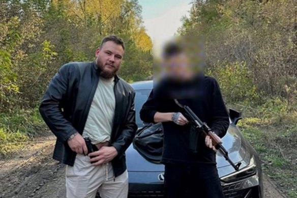 ZServers employee Dmitriy Bolshakov, 23, shows off his pistol with a friend.