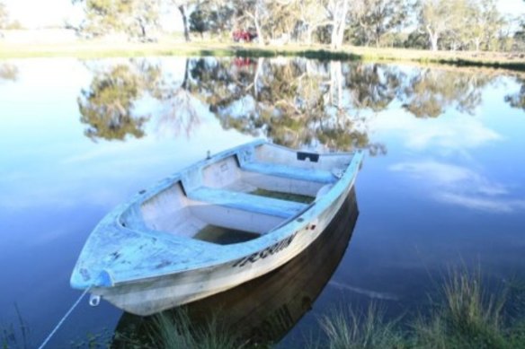 A NSW Police image of a dam and dinghy at the property where Lamarre-Condon tried to sink the men’s bodies.
