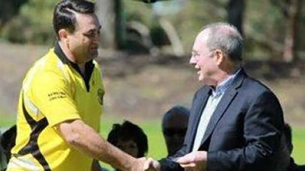 Bradley Edwards shaking hands with former WA Labor leader Eric Ripper during a presentation for his 10 years' service at Kewdale Little Athletics Club in 2013. 