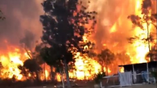 Firefighters tackle massive flames on the Cobraball firefront in central Queensland.