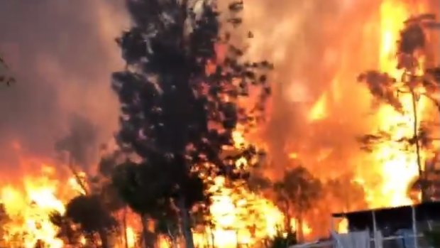 Firefighters tackle massive flames on the Cobraball fire front in central Queensland earlier this week.