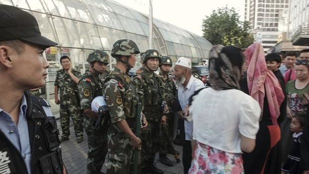 Police stand guard in a Uighur neighbourhood in the Xinjiang region.  