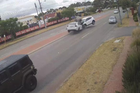 CCTV captures the moment the Holden Commodore Brandon Lee Kelly was a passenger in crashes with another car during a police chase in Guildford.