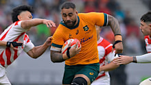Lukhan Salakaia-Loto of Australia runs with the ball.