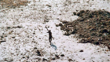 A file photo of a lone Sentinelese tribesman aiming his bow at an Indian coast guard helicopter.