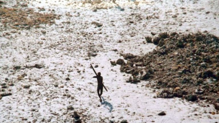 A file photo of a lone Sentinelese tribesman aiming his bow at an Indian coast guard helicopter.