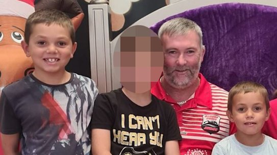 Heartbroken father Joseph Shorey (seated) with Sheldon (middle with light blue jaws shirt) and Shane (far left). Both boys died in an alleged hit and run accident in Wellington on January 5. 