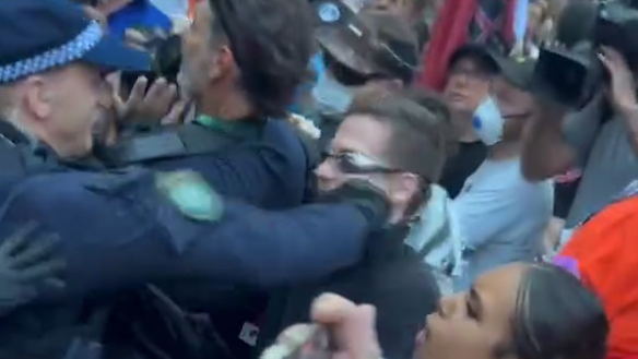 A police officer throws a punch.