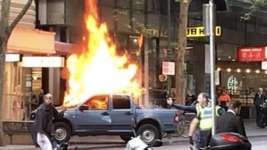 The blazing vehicle on Bourke Street.
