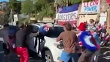 Roosters fans surround Andrew Johns.
