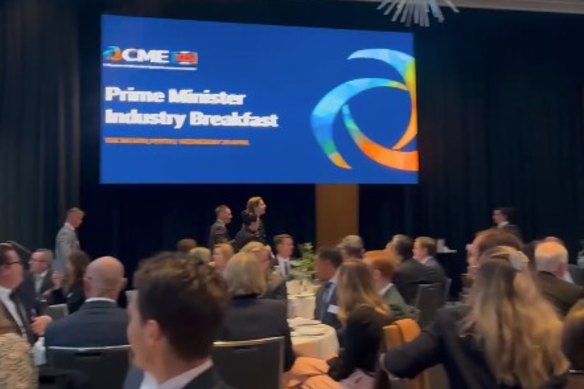 The protesters being escorted out of the CME breakfast at The Westin in Perth.