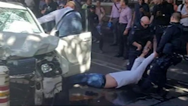 Saaed Noori is dragged from the car in Flinders Street after the attack.