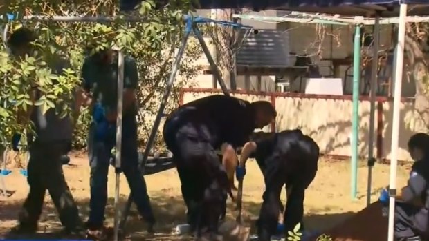 Police excavate a backyard in the southern Queensland town of Chinchilla in December last year.