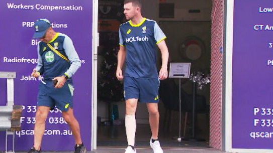 A despondent Josh Hazlewood wears a compression bandage on his calf.
