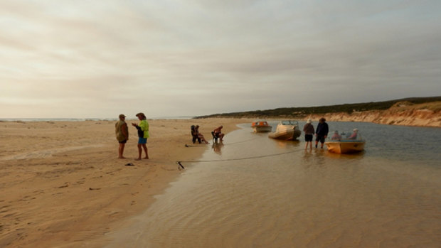 Hut owners frequently gather at the mouth of the river for sunset.