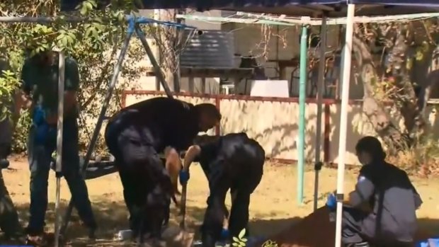 Police excavate a backyard in the southern Queensland town of Chinchilla. 