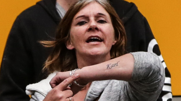 One of Karl Hague's supporters shows off her tattoo of his name.