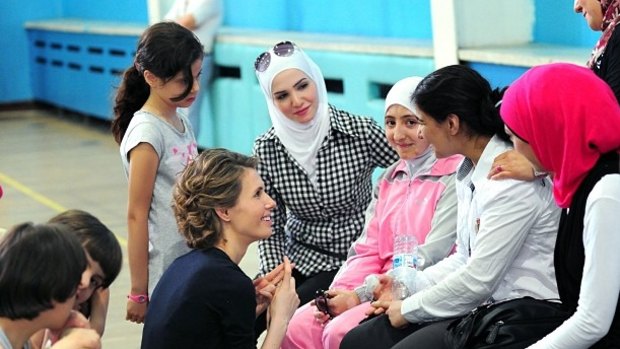 Asma al-Assad speaks to young women in 2013.