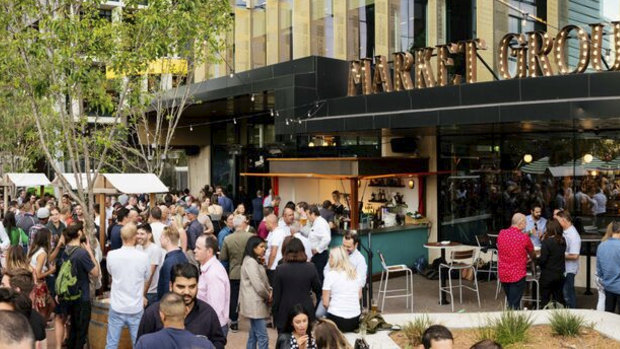 Punters at Perth's Market Grounds enjoy the vibrant outdoor area.