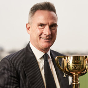 Former VRC chief executive officer Neil Wilson with the Melbourne Cup trophy at the course.