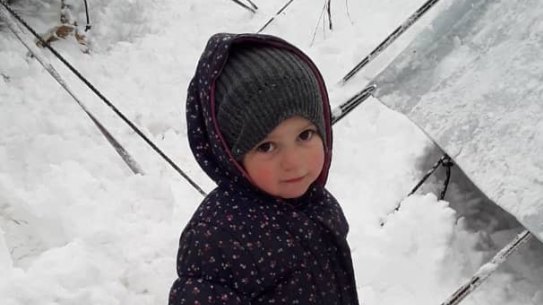 Fatema, 2, the daughter of Mariam Dabboussy and granddaughter of activist Kamalle Dabboussy, in the snow at al-Hawl camp this week.