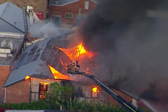 Firefighting cranes were called in as a Brisbane fire spread to multiple buildings at peak hour on Wednesday.