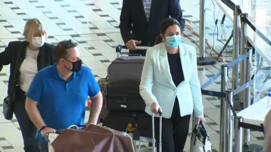 Queensland Premier Annastacia Palaszczuk and Brisbane Lord Mayor Adrian Shrinner arrive at Brisbane airport on Sunday.