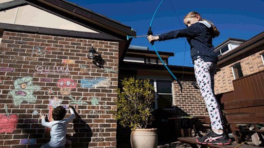 KIDS IN LOCKDOWN: Olivia 12yrs and her brother Lucas 8yrs have been allowed to graffiti on their house during lockdown, Greystanes, Sydney, 30 July 2021. Photo: Jessica Hromas

SH NEWS: Ryan Andreas, 10, of Kellyville can’t wait to get on his bike to ride after completing his home schooling. For story about children’s wellbeing during the pandemic. 29th July 2021, Photo: Wolter Peeters, The Sun Herald.

Alonso Zambrano, a year 5 student peers out of a window of his Panania home. He is enjoying lockdown, having his parents, who work in construction, at home and playing games online with his friends. 30 Juky 2021. Photo:Jessica Hromas
