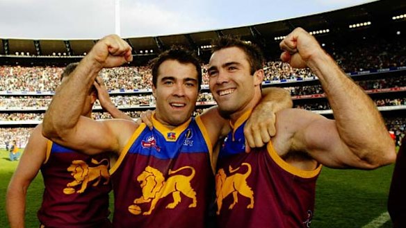 Chris (left) and Brad Scott celebrate their 2002 Brisbane Lions premiership win.