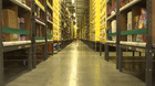 An automated transport robot moves between shelving units containing goods at Amazon’s fulfillment centre in Kolbaskowo, Poland.