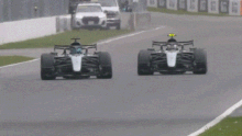 Mercedes car passes a rival in an F1 race.