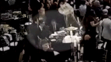 The footage shows the two Liberal MPs sitting at a table and leaning in towards each other, before Guy appears to place his arm on Deeming’s back.