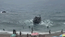 Beachgoers in southern Spain were stunned when a people smuggling boat dropped about 60 migrants close to the sands.