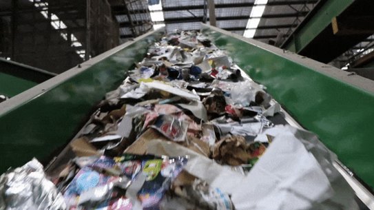 Waste being sorted at a recycling facility. Vision: Planet Art