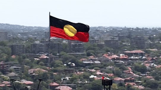 Aboriginal flag flies atop the Sydney Harbour Bridge.