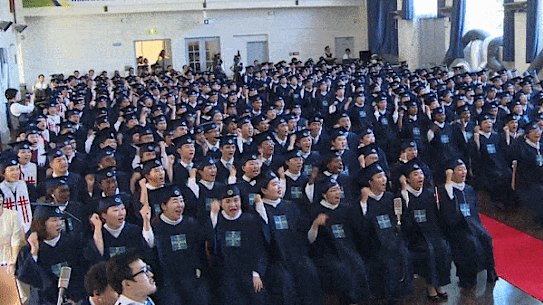 Hundreds of students at their "passover" in Australia last year, where they cheered and applauded speakers including Lee Man-Hee.