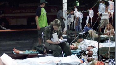 An Australian air force medic sits with injured Australians awaiting evacuation after the 2002 bombing.