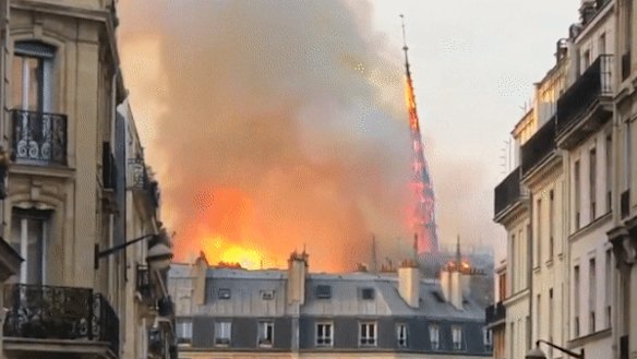 The spire of Notre-Dame collapsing in flames. 