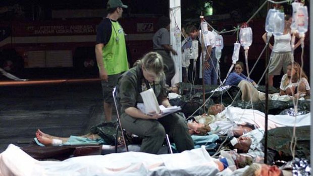 An Australian air force medic sits with injured Australians awaiting evacuation after the 2002 bombing.