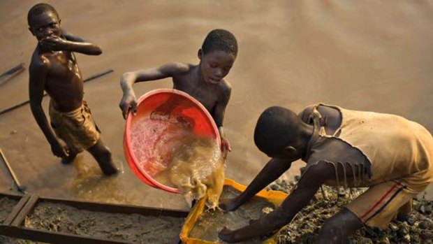 Boys pan for gold on a riverside at Iga in the resource-rich Ituri region of eastern Congo. 