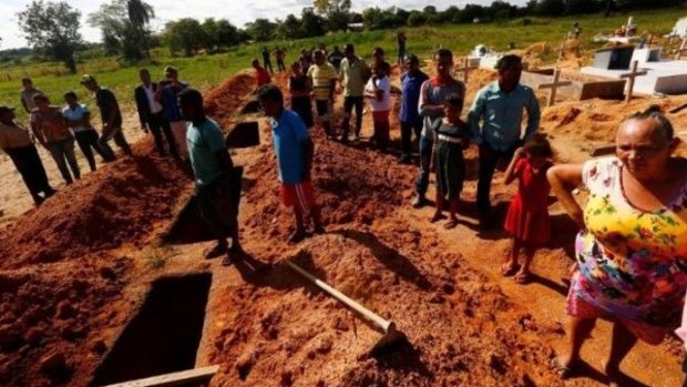 Relatives of farmers killed by Brazilian police attend their burial in 2017.