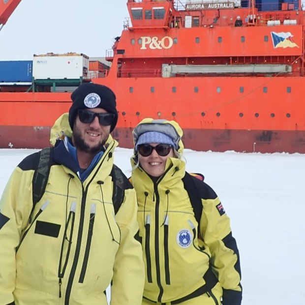 Davis station expeditioners, weather observer husband and wife team Liam and Amy Carroll, after stepping off Australia’s icebreaker, Aurora Australis onto the sea ice for the first time.