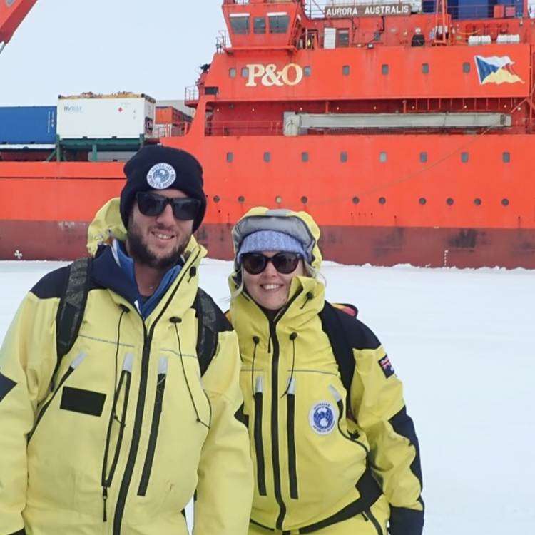 Davis station expeditioners, weather observer husband and wife team Liam and Amy Carroll, after stepping off Australia’s icebreaker, Aurora Australis onto the sea ice for the first time.