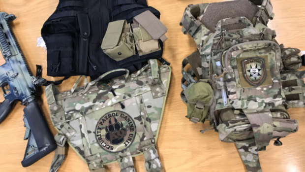 Tactical clothing, weapons, holsters, military-style clothing, different police service patches and animals were found.