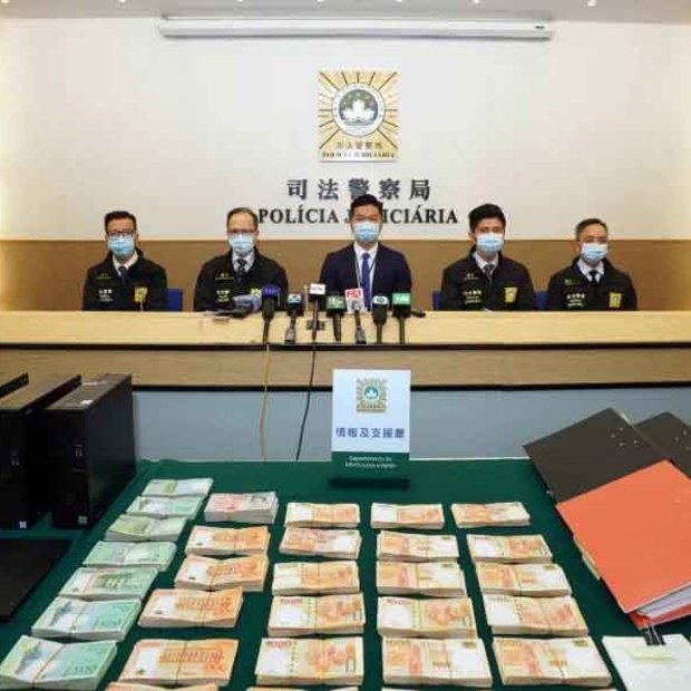 Computers, mobile phones and cash on display after the Chau arrest.