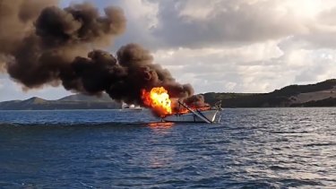 The yacht burns off Moreton Island on Friday morning.