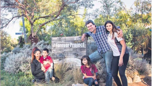 Chris and Astrid, and their children River, Akira and Sarah out the front of the "Hami Hill Sustainable Home”. 
